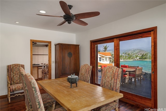 dining area featuring a mountain view, ceiling fan, and dark wood-type flooring