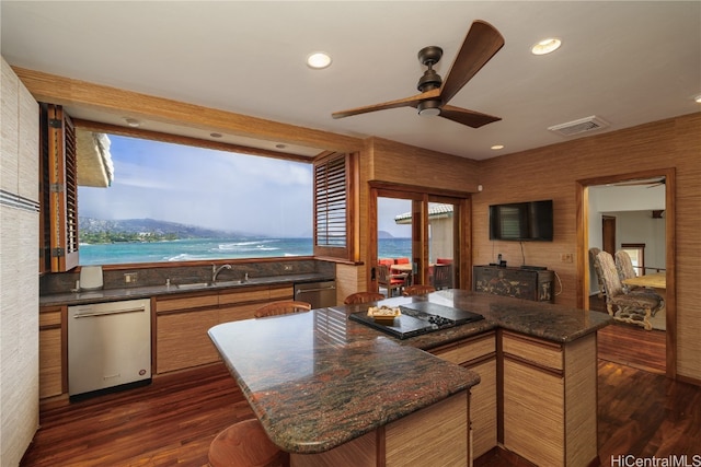 kitchen with dishwasher, dark hardwood / wood-style floors, ceiling fan, and black cooktop