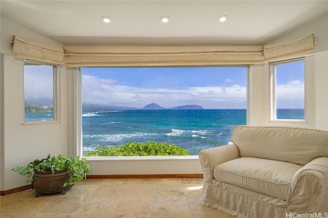 living area featuring a water view and a healthy amount of sunlight