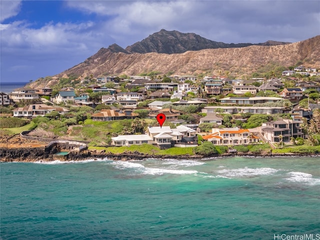 birds eye view of property with a water and mountain view