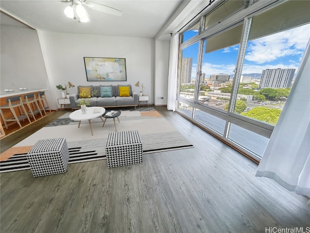 living area with hardwood / wood-style flooring and ceiling fan