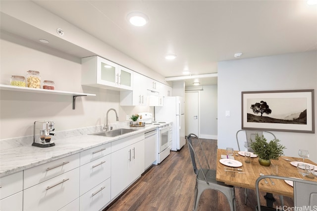 kitchen with dark wood-type flooring, white appliances, sink, and white cabinets