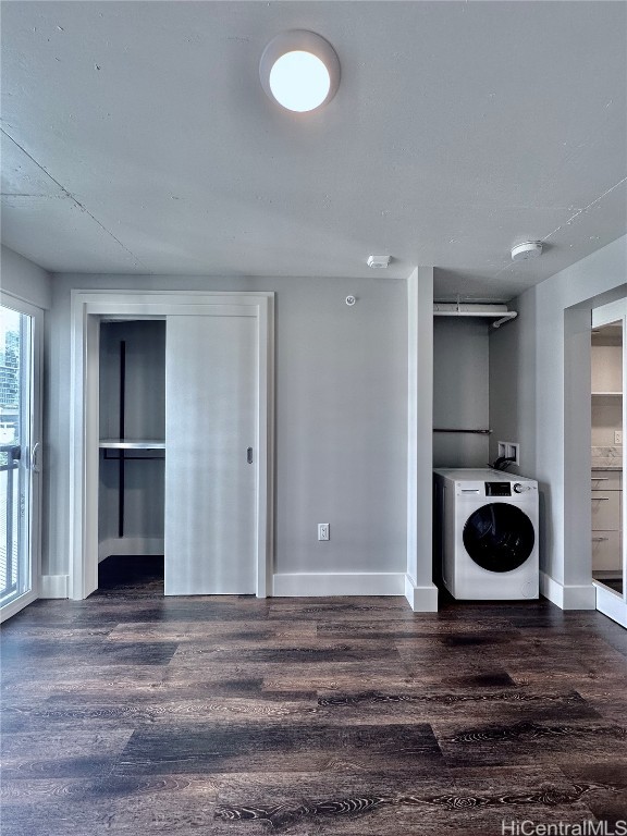 laundry area with dark hardwood / wood-style floors and washer / dryer