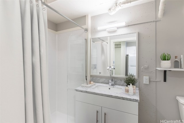 bathroom featuring toilet, vanity, and curtained shower