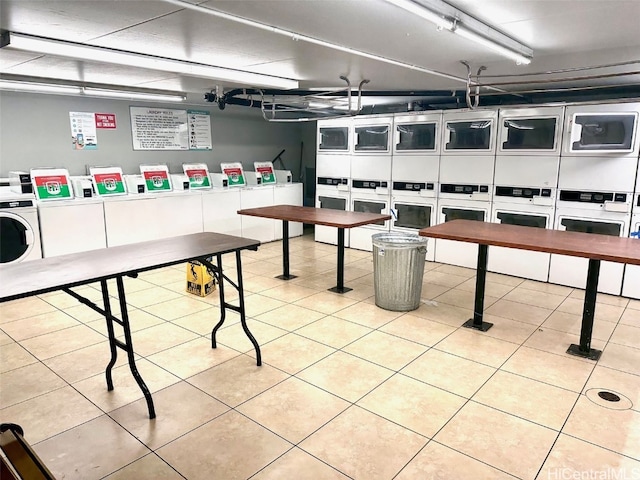 rec room with stacked washing maching and dryer, light tile patterned floors, and separate washer and dryer