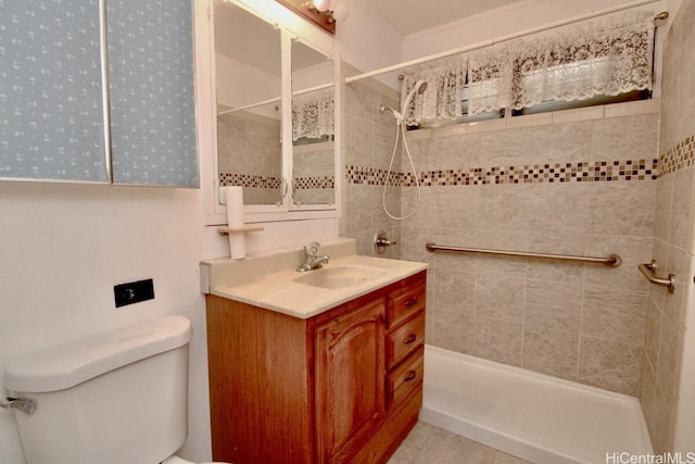 bathroom featuring tile patterned floors, vanity, a tile shower, and toilet