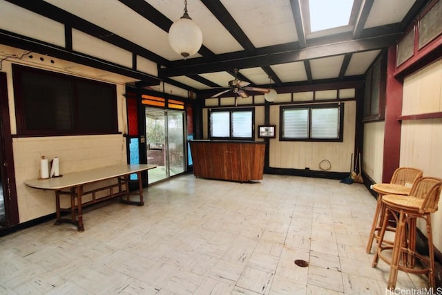 interior space featuring ceiling fan and beam ceiling