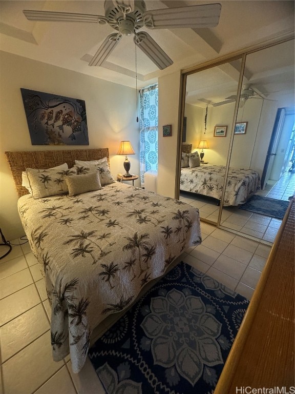 bedroom with ceiling fan, a closet, and light tile patterned floors