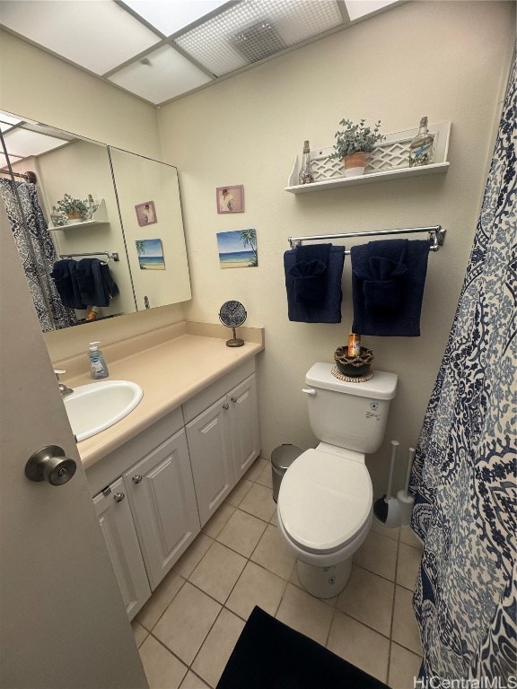 bathroom featuring tile patterned floors, vanity, and toilet