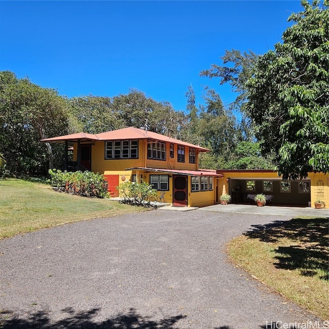 view of front facade with a carport and a front yard