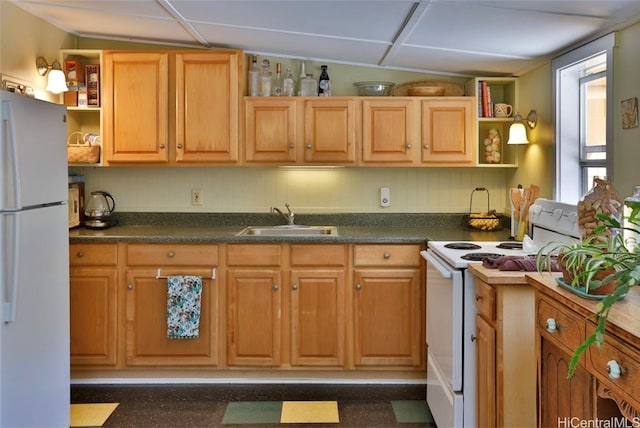 kitchen with sink, white appliances, and vaulted ceiling