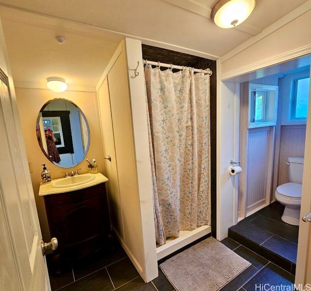 bathroom featuring a shower with shower curtain, tile patterned flooring, vanity, and toilet