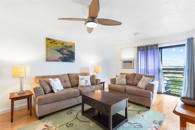 living room featuring light hardwood / wood-style flooring, ceiling fan, and cooling unit