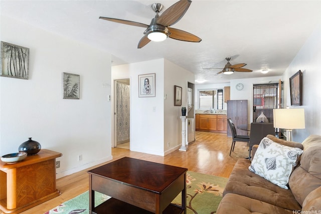 98-626 Moanalua Loop Unit 311, Aiea, HI 96701 - living room featuring ceiling fan, light wood-style floors, and baseboards