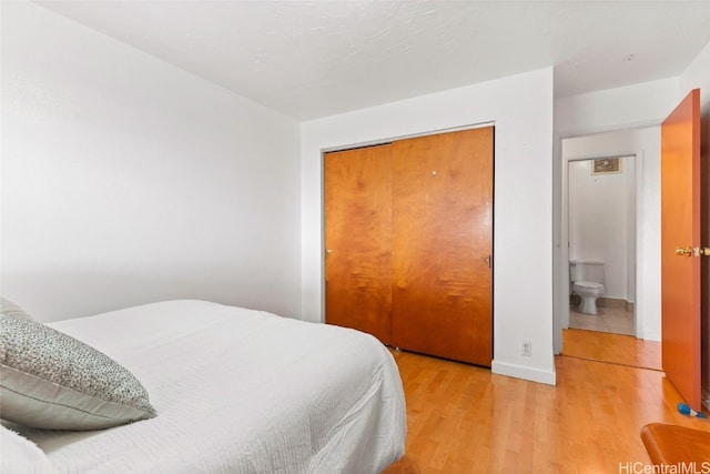 bedroom featuring light hardwood / wood-style floors and a closet