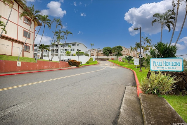 98-626 Moanalua Loop Unit 311, Aiea, HI 96701 - view of asphalt street with traffic signs, a residential view, curbs, and street lighting
