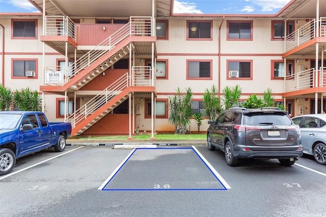 98-626 Moanalua Loop Unit 311, Aiea, HI 96701 - view of property with stairs and uncovered parking
