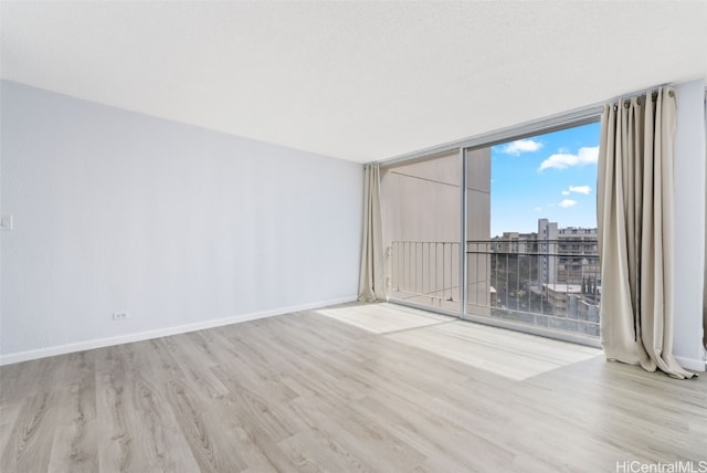 unfurnished room featuring light hardwood / wood-style flooring