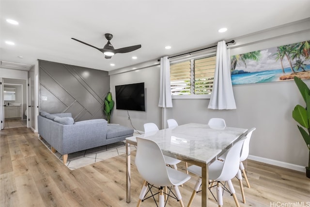 dining space featuring light hardwood / wood-style floors and ceiling fan