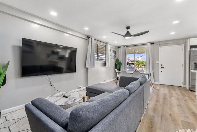 living room featuring light hardwood / wood-style floors and ceiling fan