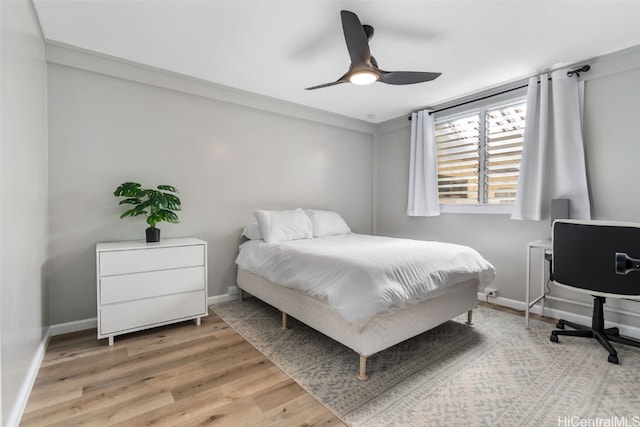 bedroom featuring ornamental molding, light hardwood / wood-style floors, and ceiling fan