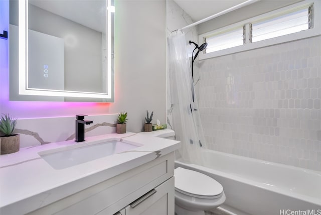 full bathroom featuring toilet, vanity, and shower / bath combination with curtain