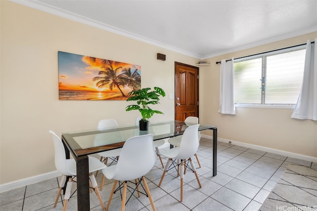 tiled dining area featuring crown molding