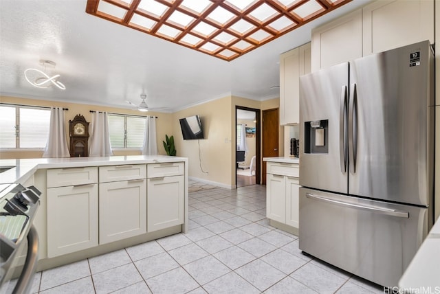 kitchen featuring ornamental molding, ceiling fan, appliances with stainless steel finishes, and light tile patterned flooring