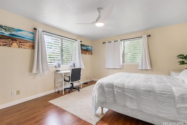 bedroom featuring dark hardwood / wood-style flooring and ceiling fan