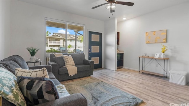 living room with ceiling fan and light hardwood / wood-style floors