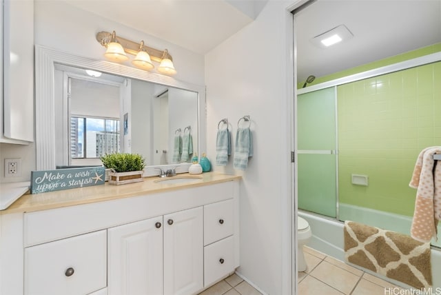 full bathroom featuring toilet, vanity, combined bath / shower with glass door, and tile patterned floors