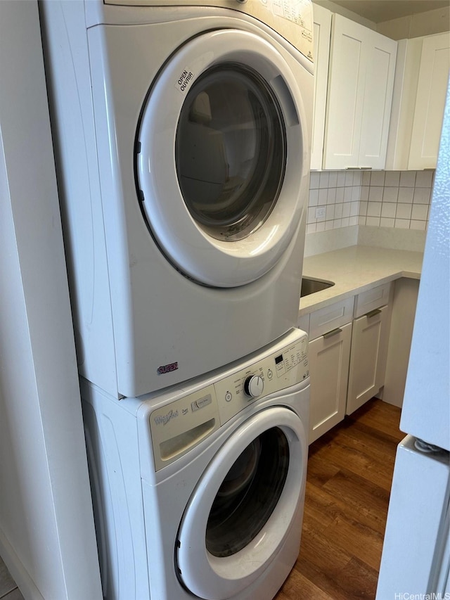 950 Lehua Ave Unit 801, Pearl City, HI 96782 - laundry room with stacked washer and clothes dryer, cabinet space, and dark wood-style flooring