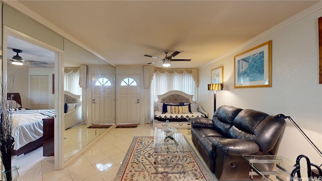 living room featuring light tile patterned floors, a wealth of natural light, ornamental molding, and ceiling fan