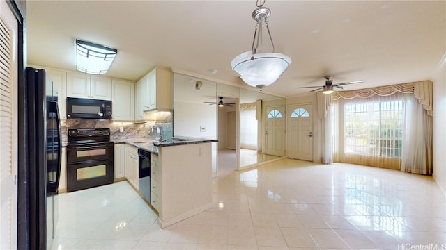 kitchen with black appliances, tasteful backsplash, light tile patterned floors, sink, and pendant lighting