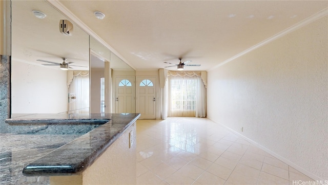 entrance foyer featuring crown molding, light tile patterned floors, and ceiling fan