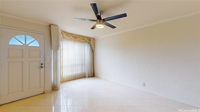 foyer with ceiling fan, crown molding, and light tile patterned flooring