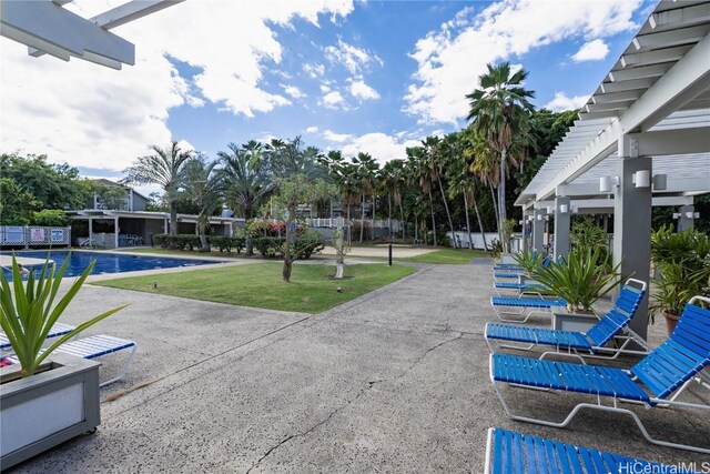 view of patio with a community pool and a pergola