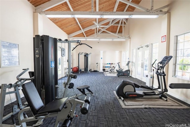 workout area featuring carpet, high vaulted ceiling, wooden ceiling, and baseboards