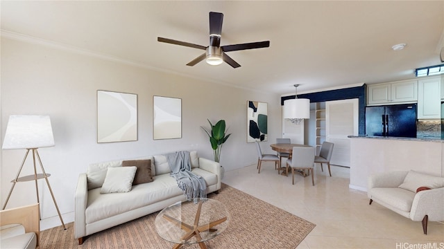 living room featuring ornamental molding, a ceiling fan, and light tile patterned floors