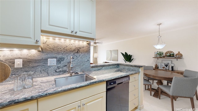 kitchen with tasteful backsplash, dishwasher, dark stone countertops, pendant lighting, and a sink