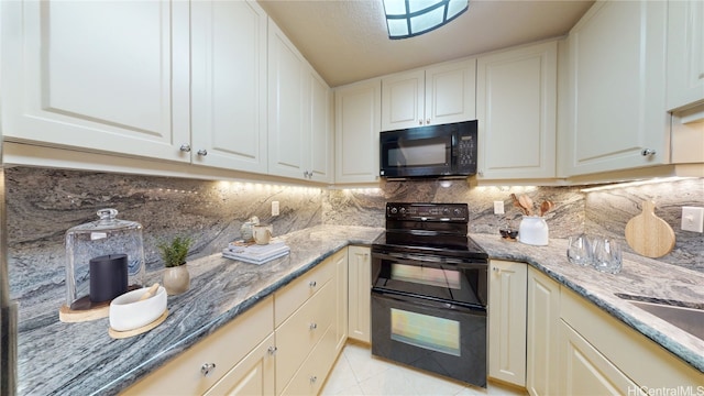 kitchen with light tile patterned floors, tasteful backsplash, dark stone countertops, black appliances, and white cabinetry