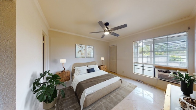 bedroom featuring light tile patterned floors, ceiling fan, a closet, and crown molding