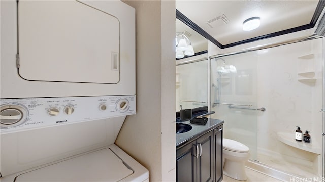 laundry room featuring stacked washer and dryer, laundry area, visible vents, and crown molding