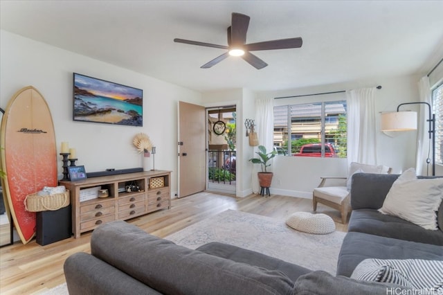 living room with light hardwood / wood-style floors and ceiling fan