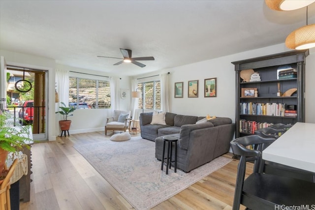 living room with hardwood / wood-style flooring and ceiling fan