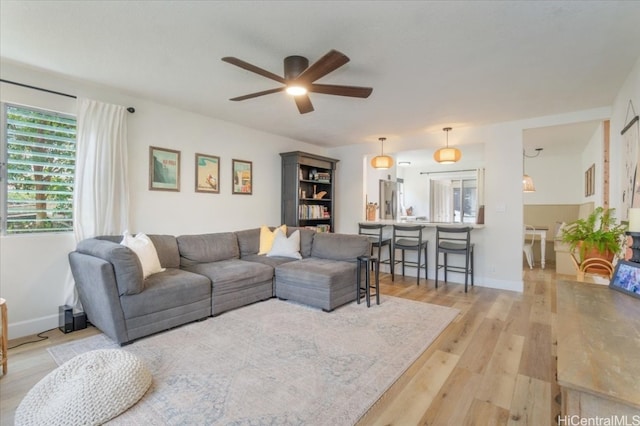 living room featuring ceiling fan and light hardwood / wood-style floors