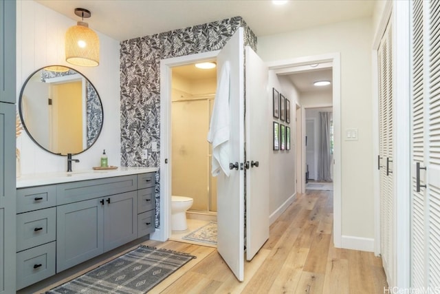 bathroom featuring toilet, vanity, and hardwood / wood-style flooring