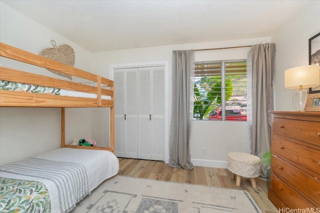 bedroom featuring light hardwood / wood-style floors and a closet