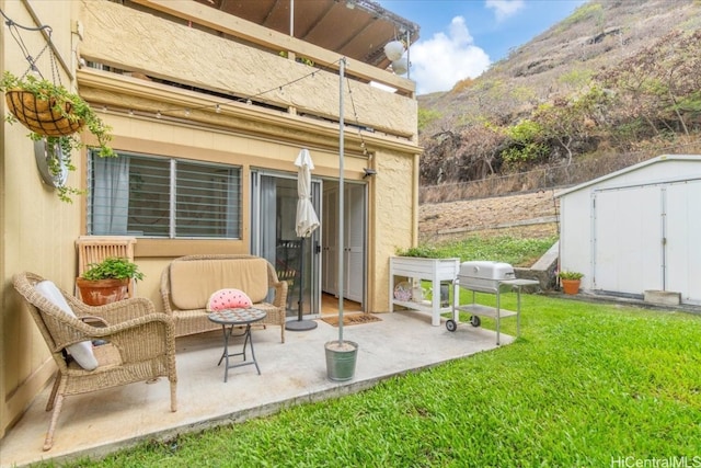 view of patio / terrace featuring a storage unit