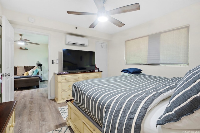 1080 Ala Napunani St Unit 403, Honolulu, HI 96818 - bedroom featuring a wall mounted air conditioner, light wood finished floors, and ceiling fan